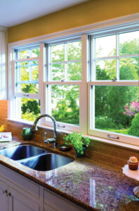 Kitchen sink with new, white-framed windows by it